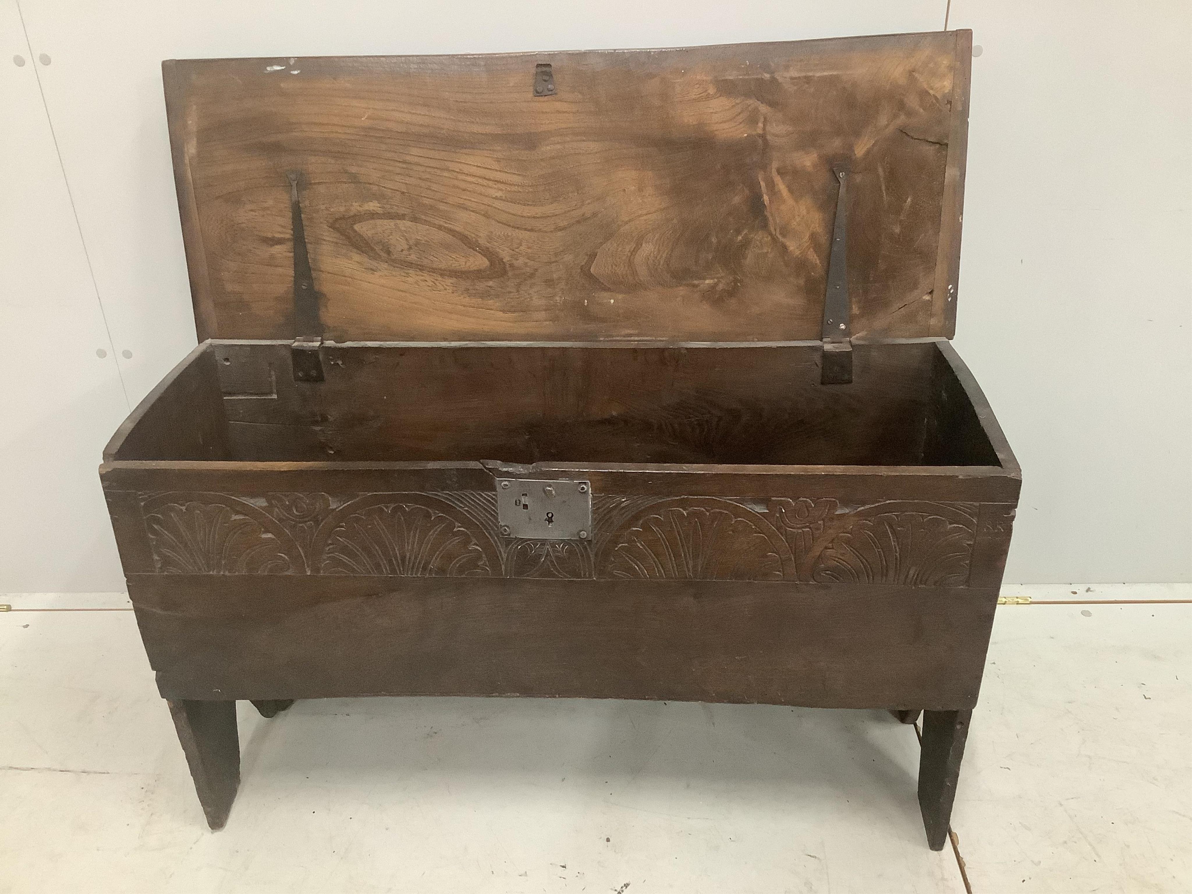 An early 18th century oak six plank coffer, with a lunette carved front, width 103cm, depth 38cm, height 61cm. Condition - fair